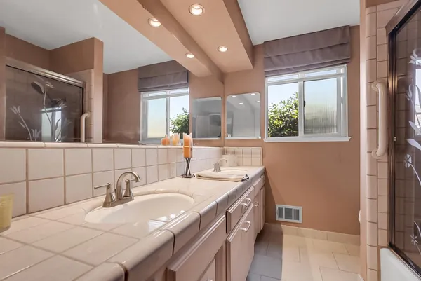 a bathroom with a granite countertop sink mirror and double