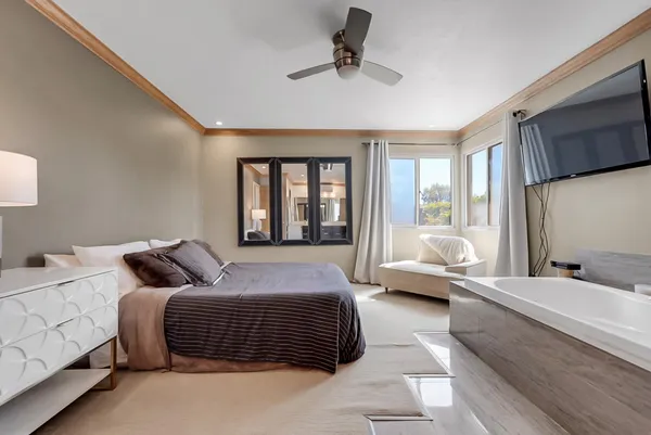 a bedroom with a bed couch and a window