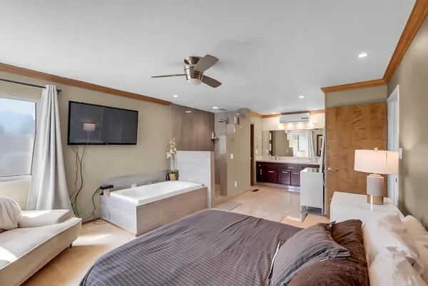 a bedroom with furniture and a mirror