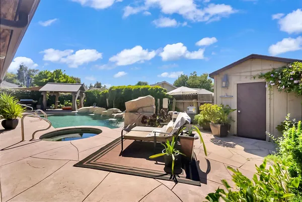 a view of a backyard with sitting area