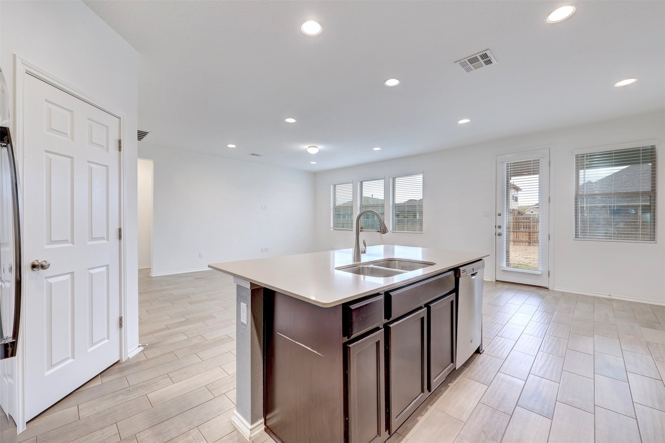 307 Simmental Loop Hutto, TX 78634 - Photo 13 of 34 A well-lit kitchen island offers a practical centerpiece in this open living space.