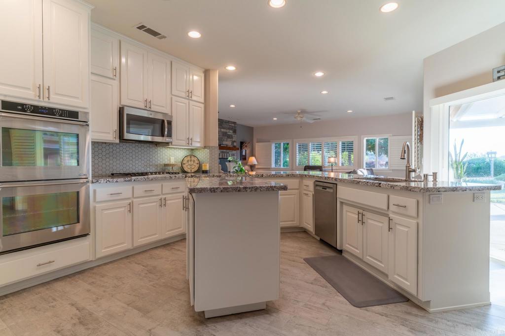 30646 Red Hawk Road Valley Center, CA 92082 - Photo 12 of 69 a kitchen with white cabinets appliances and sink