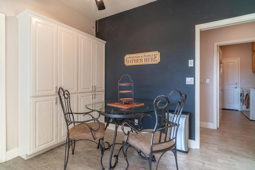 30646 Red Hawk Road Valley Center, CA 92082 - Photo 16 of 69 a dining room with furniture and wooden floor