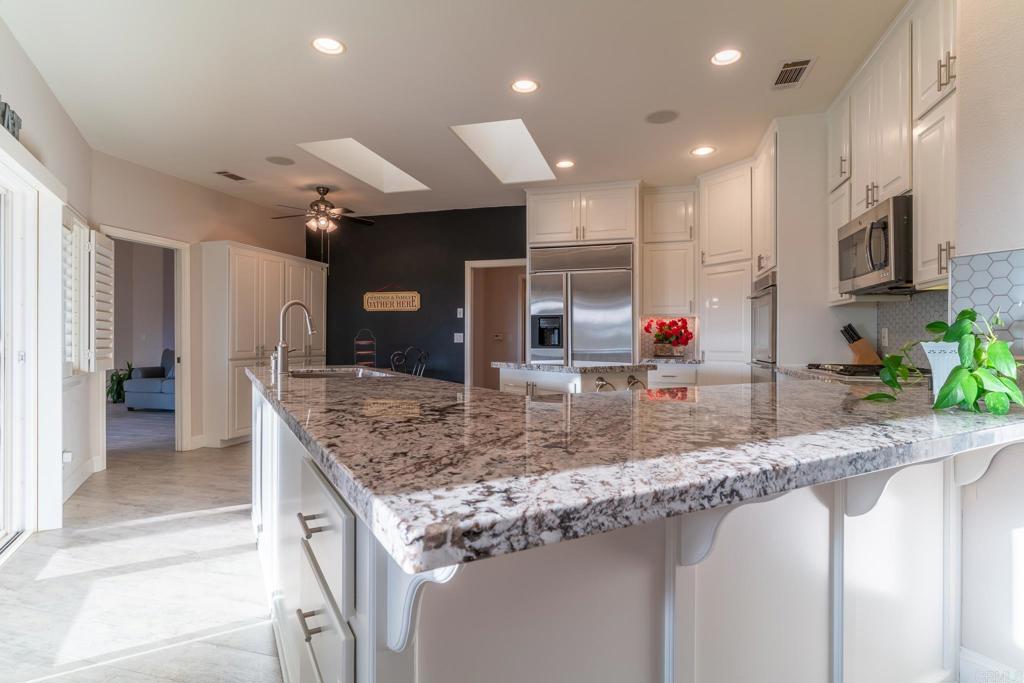 30646 Red Hawk Road Valley Center, CA 92082 - Photo 17 of 69 a view of a kitchen with kitchen island a sink appliances and a counter top space