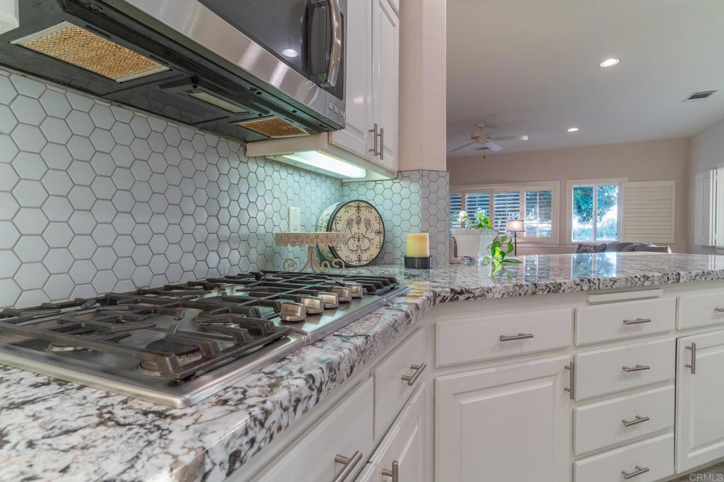 30646 Red Hawk Road Valley Center, CA 92082 - Photo 20 of 69 a kitchen with stainless steel appliances granite countertop a stove a sink and a granite counter tops
