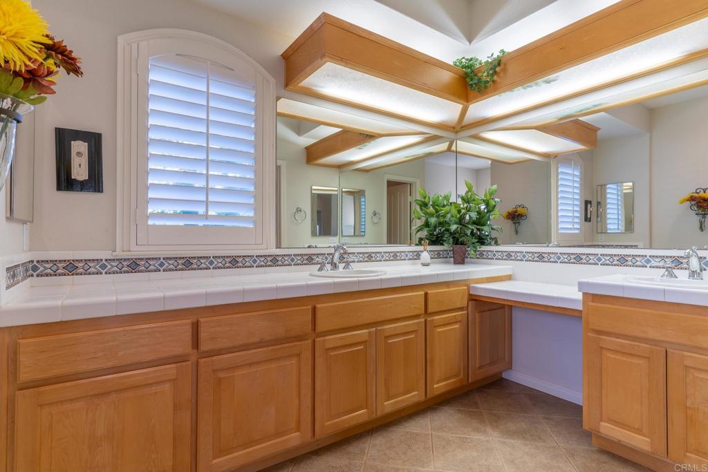 30646 Red Hawk Road Valley Center, CA 92082 - Photo 39 of 69 a bathroom with a granite countertop sink mirror and a