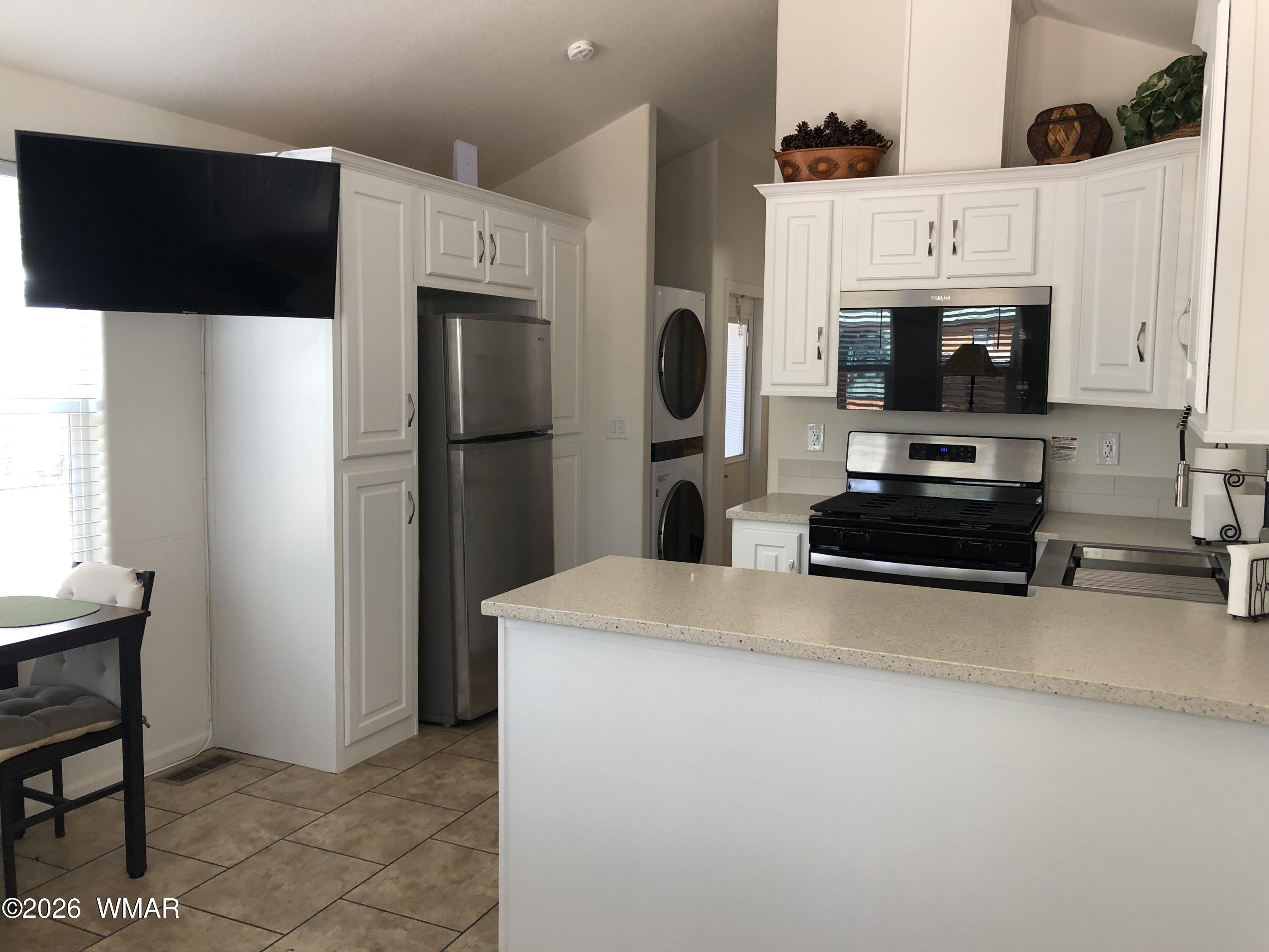2301 Turtle Creek Road Show Low, AZ 85901 - Photo 12 of 35 a kitchen with stainless steel appliances a stove a microwave and a refrigerator