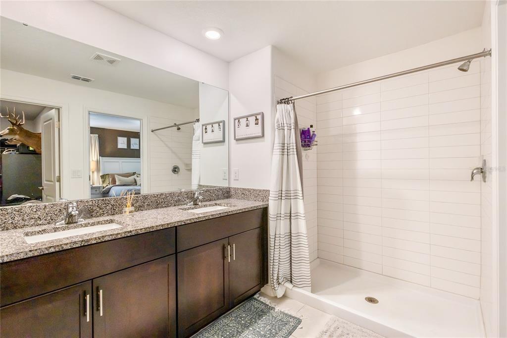 1628 Red Loop Lakeland, FL 33801 - Photo 21 of 37 a bathroom with a granite countertop sink shower and a mirror