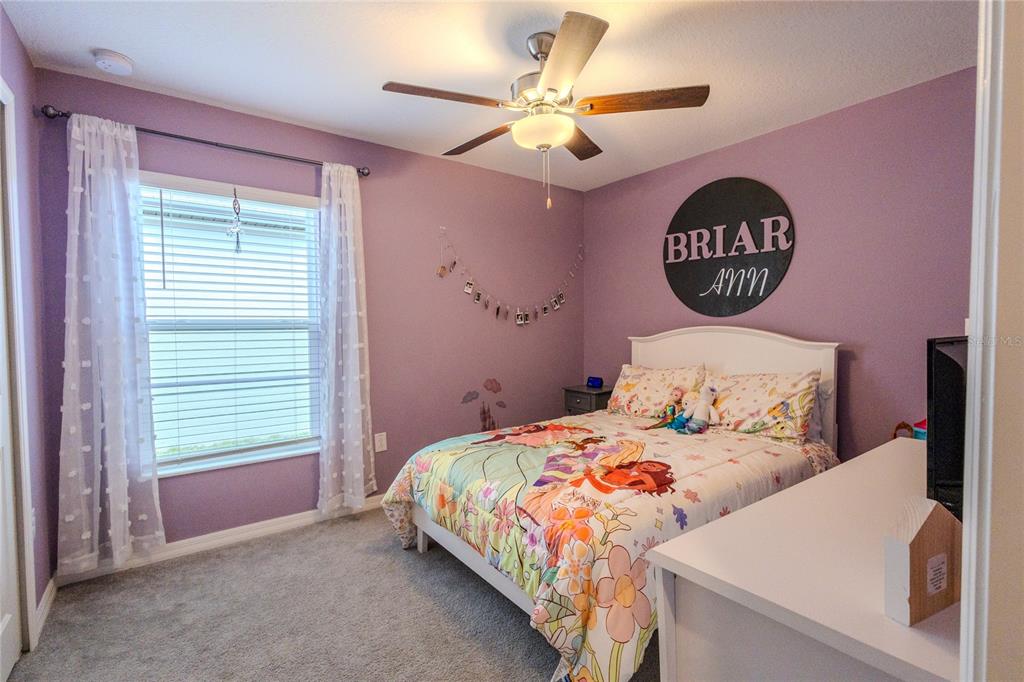 1628 Red Loop Lakeland, FL 33801 - Photo 26 of 37 a bedroom with a bed and a table