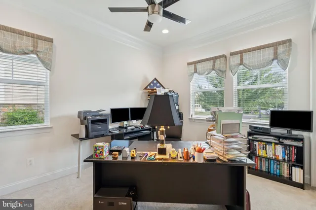 a living room with furniture and a ceiling fan