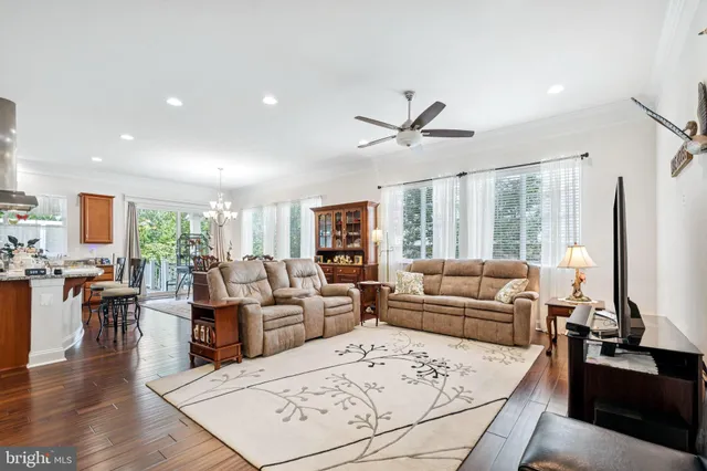 a living room with furniture window and wooden floor