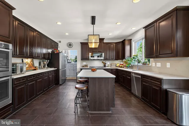 a kitchen with wooden cabinets and stainless steel appliances