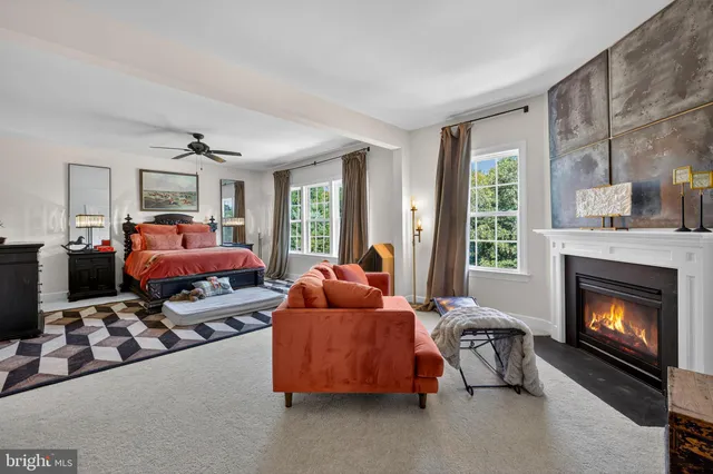 a bedroom with furniture and a fireplace