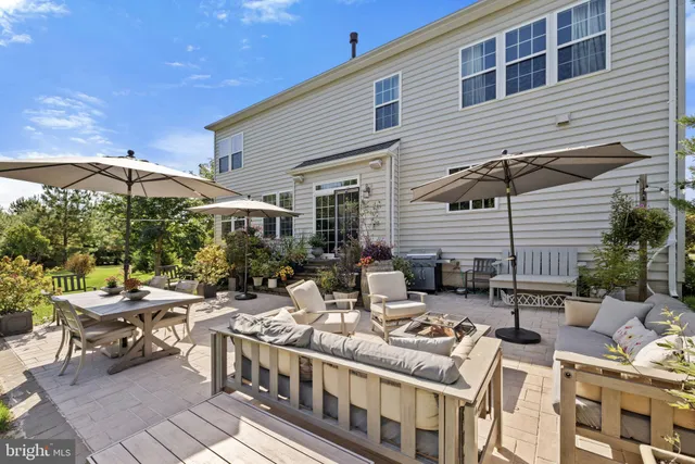 a group of table and chairs under an umbrella