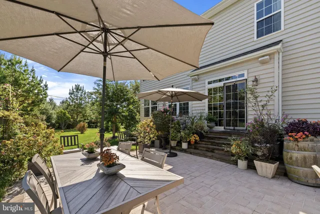 a view of a house with backyard sitting area and garden
