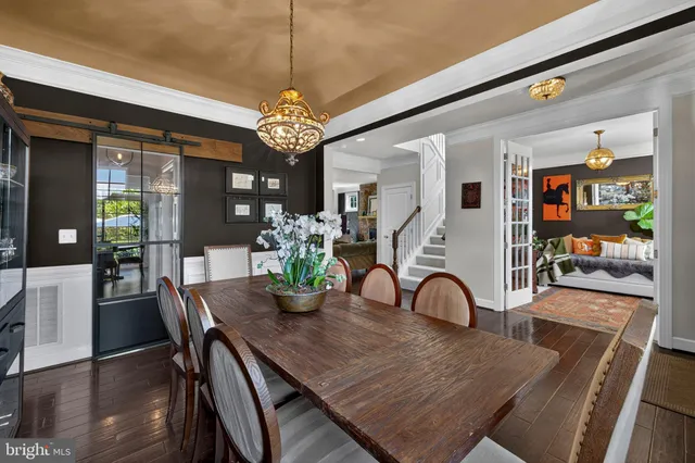 a view of a dining room with furniture wooden floor and chandelier