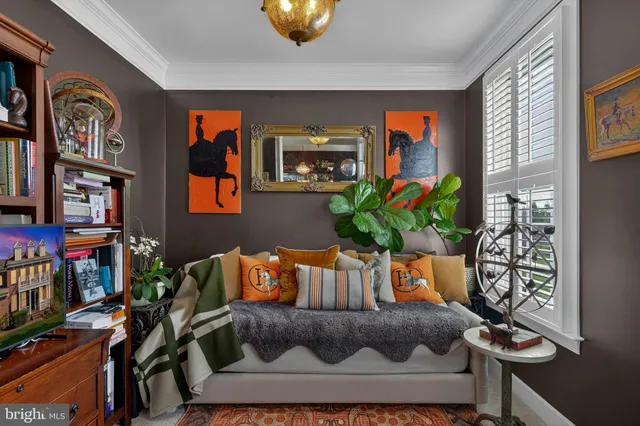 a living room with furniture and flowers