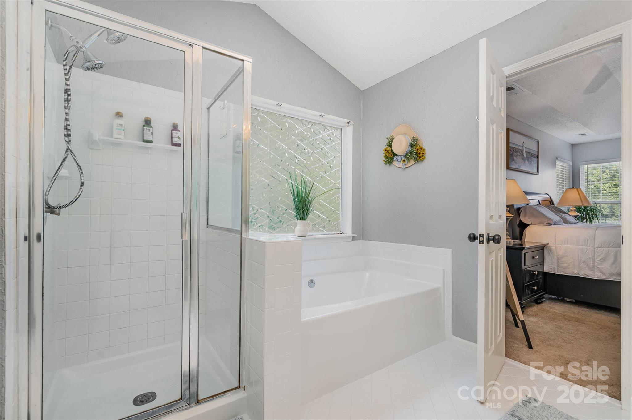 108 Shade Tree Circle Fort Mill, SC 29715 - Photo 18 of 36 a bathroom with a bathtub and a shower