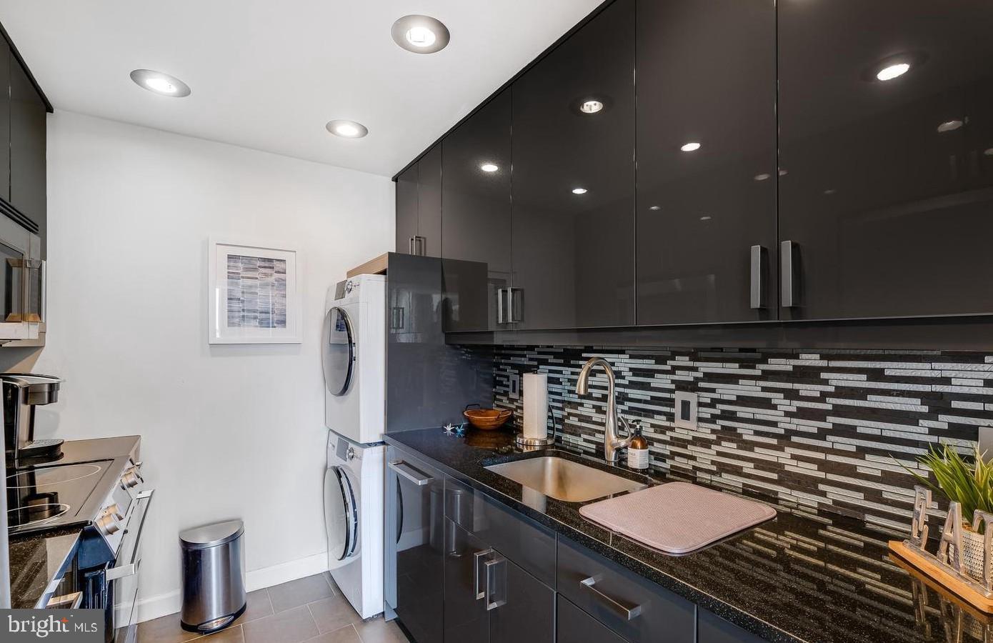 955 26th Street Northwest, Unit 506 Washington, DC 20037 - Photo 1 of 12 a kitchen with refrigerator and sink