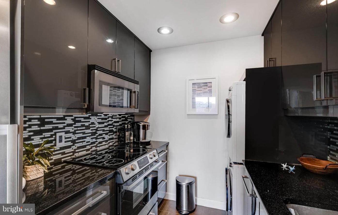 955 26th Street Northwest, Unit 506 Washington, DC 20037 - Photo 3 of 12 a kitchen that has a sink and a stove