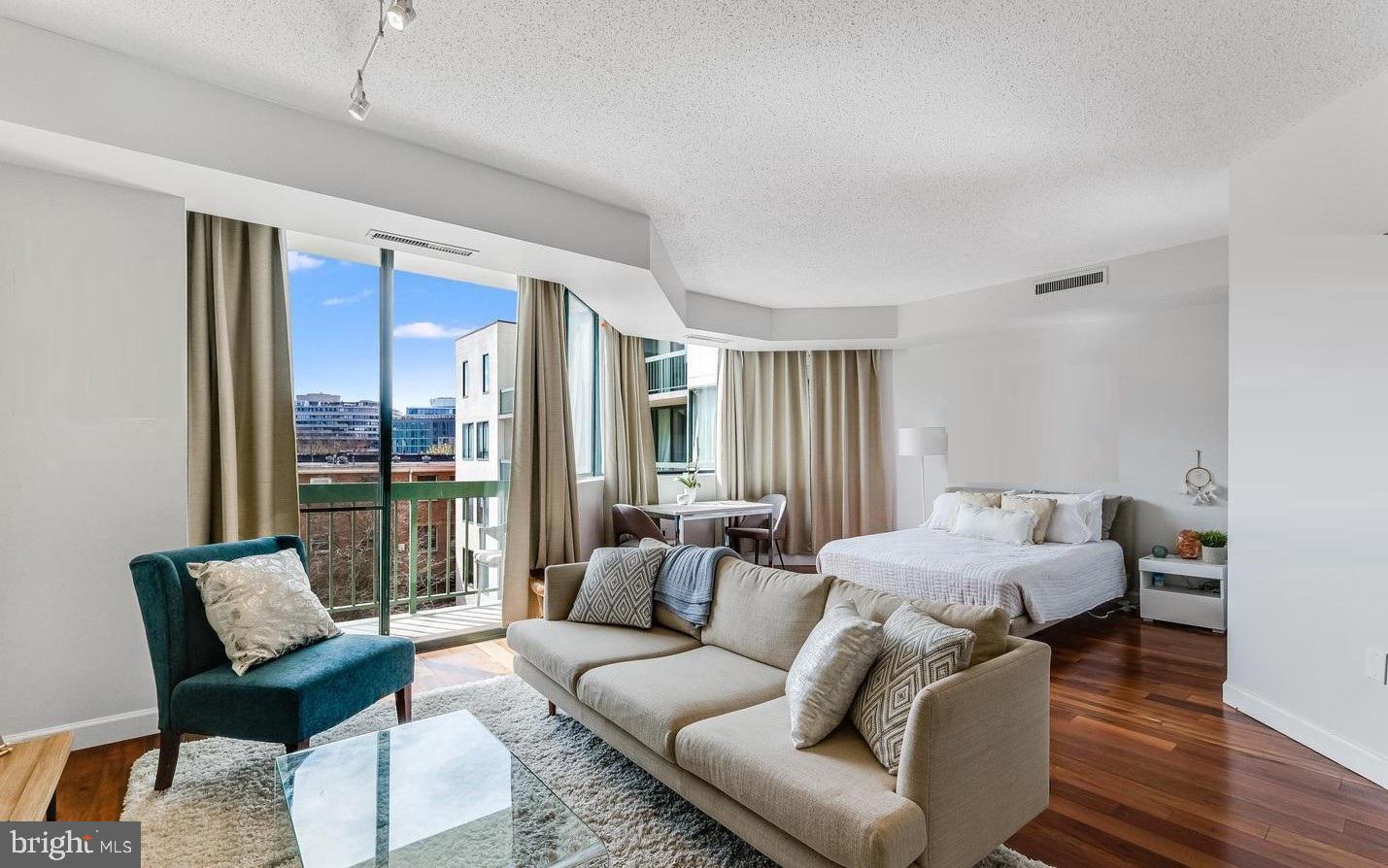 955 26th Street Northwest, Unit 506 Washington, DC 20037 - Photo 4 of 12 a living room with furniture and a floor to ceiling window