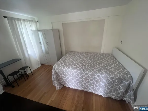 a bedroom with a bed and a mirror