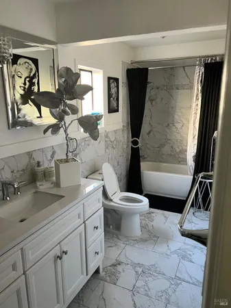 a bathroom with a toilet sink and mirror