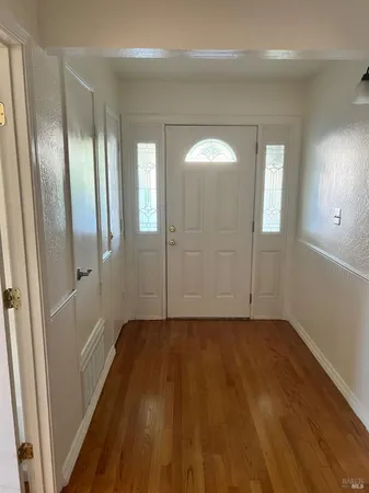a view of hallway with wooden floor