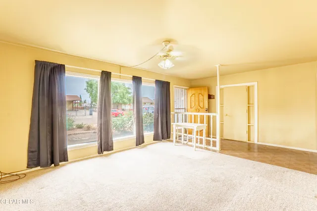 a bedroom with a bed and a large window