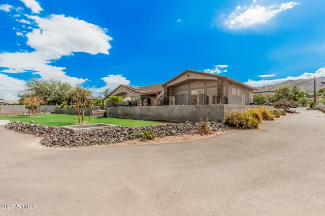 a front view of a house with a garden
