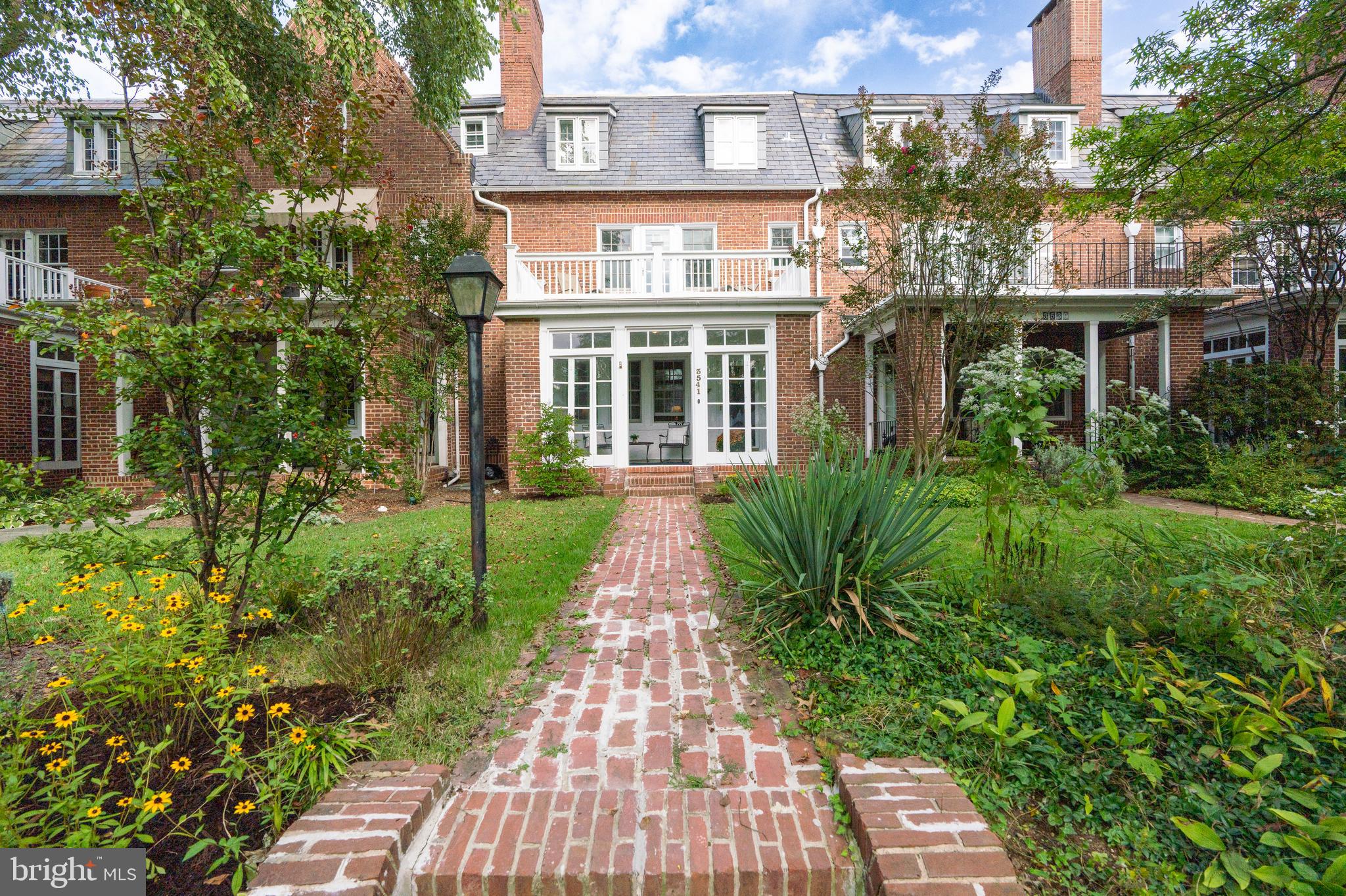 3541 Newland Road Baltimore, MD 21218 - Photo 2 of 68 a front view of a residential apartment building with a yard and potted plants