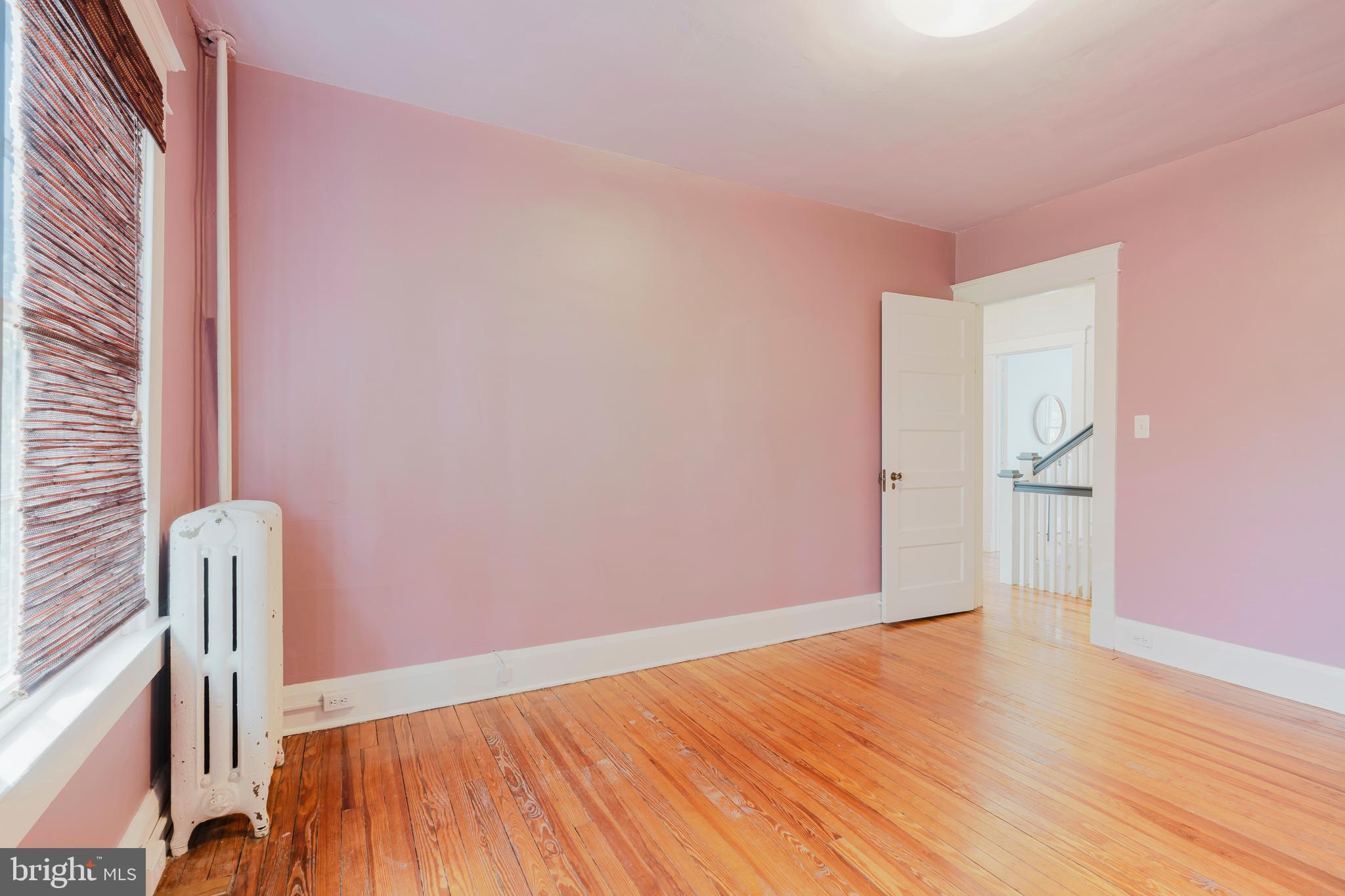 3541 Newland Road Baltimore, MD 21218 - Photo 31 of 68 a view of an empty room with wooden floor and a window
