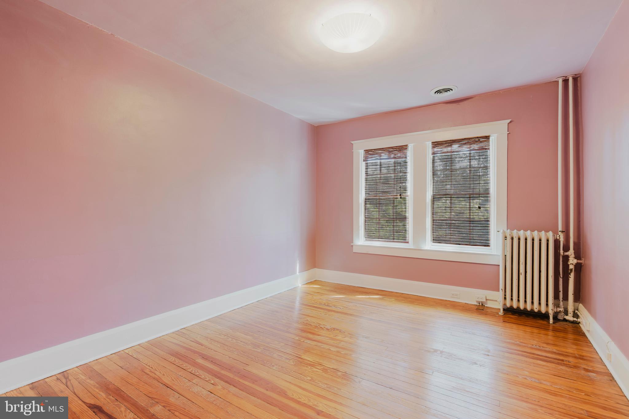 3541 Newland Road Baltimore, MD 21218 - Photo 33 of 68 a view of an empty room with wooden floor and a window
