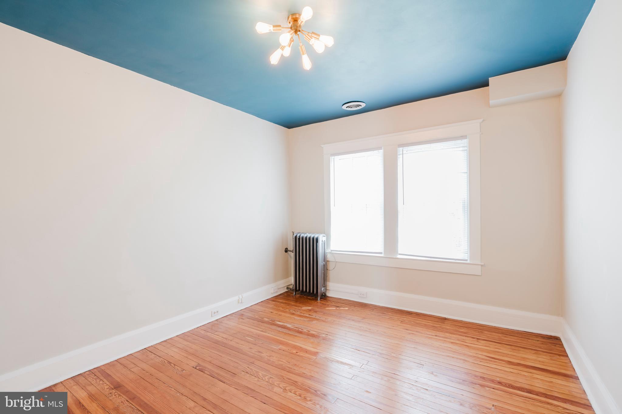 3541 Newland Road Baltimore, MD 21218 - Photo 35 of 68 an empty room with wooden floor chandelier fan and windows