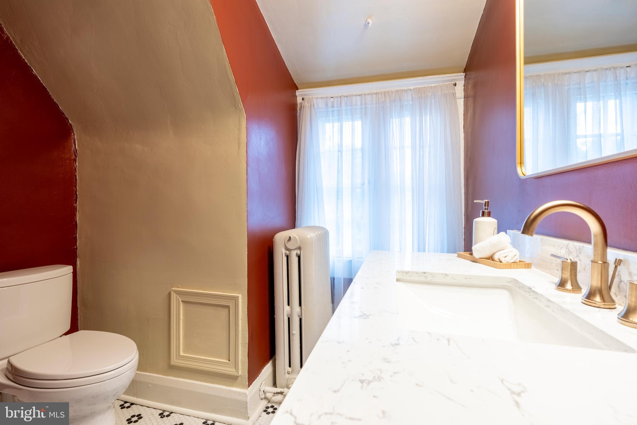 3541 Newland Road Baltimore, MD 21218 - Photo 51 of 68 a bathroom with a toilet sink and a mirror