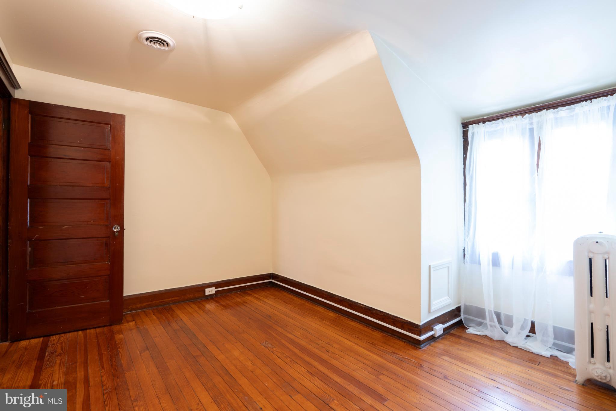 3541 Newland Road Baltimore, MD 21218 - Photo 56 of 68 a view of an empty room with wooden floor and a window