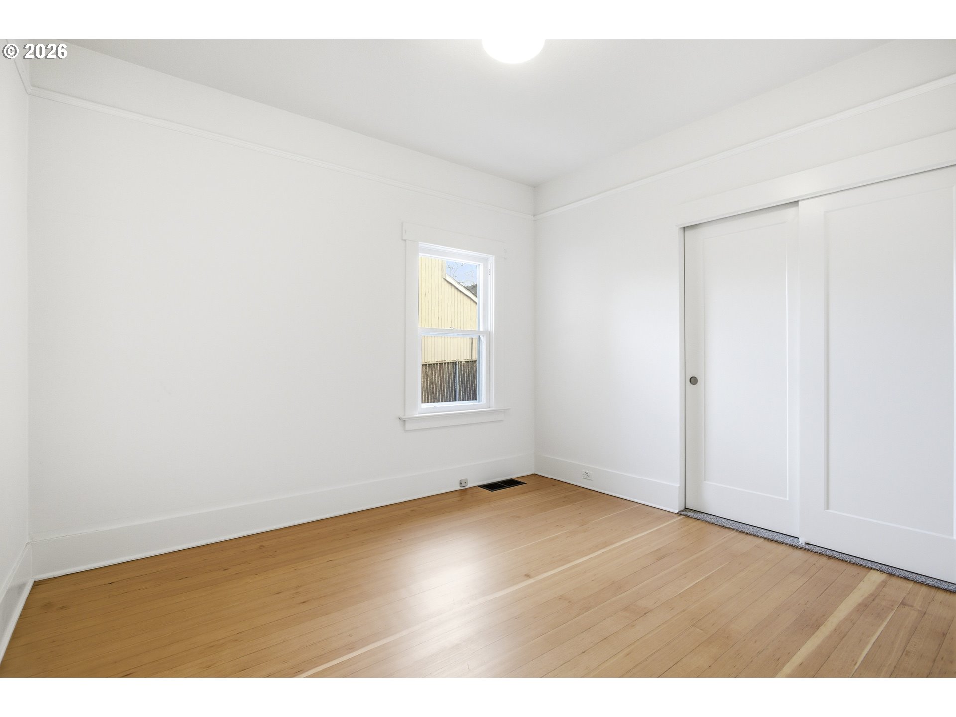 4036 Northeast Senate Street Portland, OR 97232 - Photo 15 of 48 an empty room with wooden floor and windows