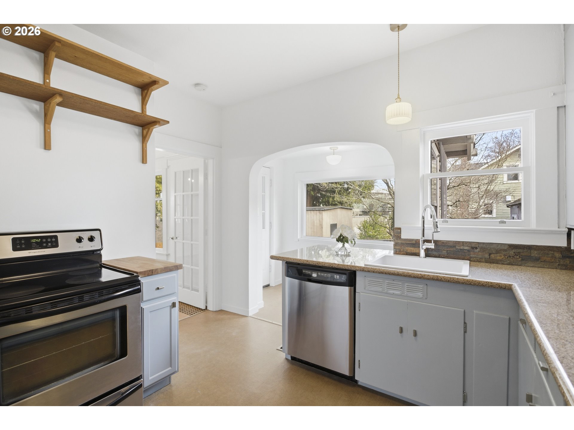 4036 Northeast Senate Street Portland, OR 97232 - Photo 17 of 48 a kitchen with a sink stove and microwave