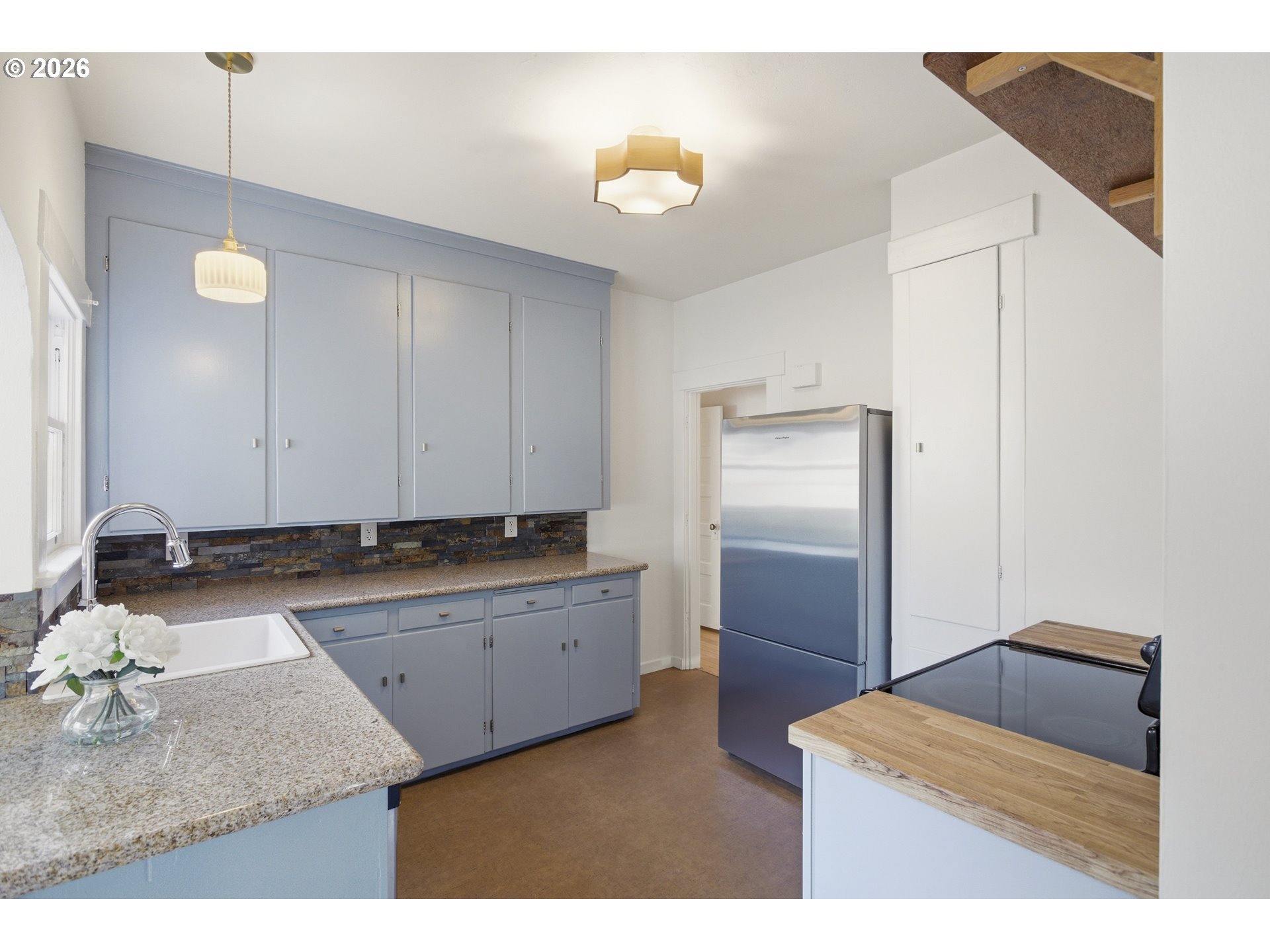 4036 Northeast Senate Street Portland, OR 97232 - Photo 18 of 48 a kitchen with kitchen island sink and refrigerator