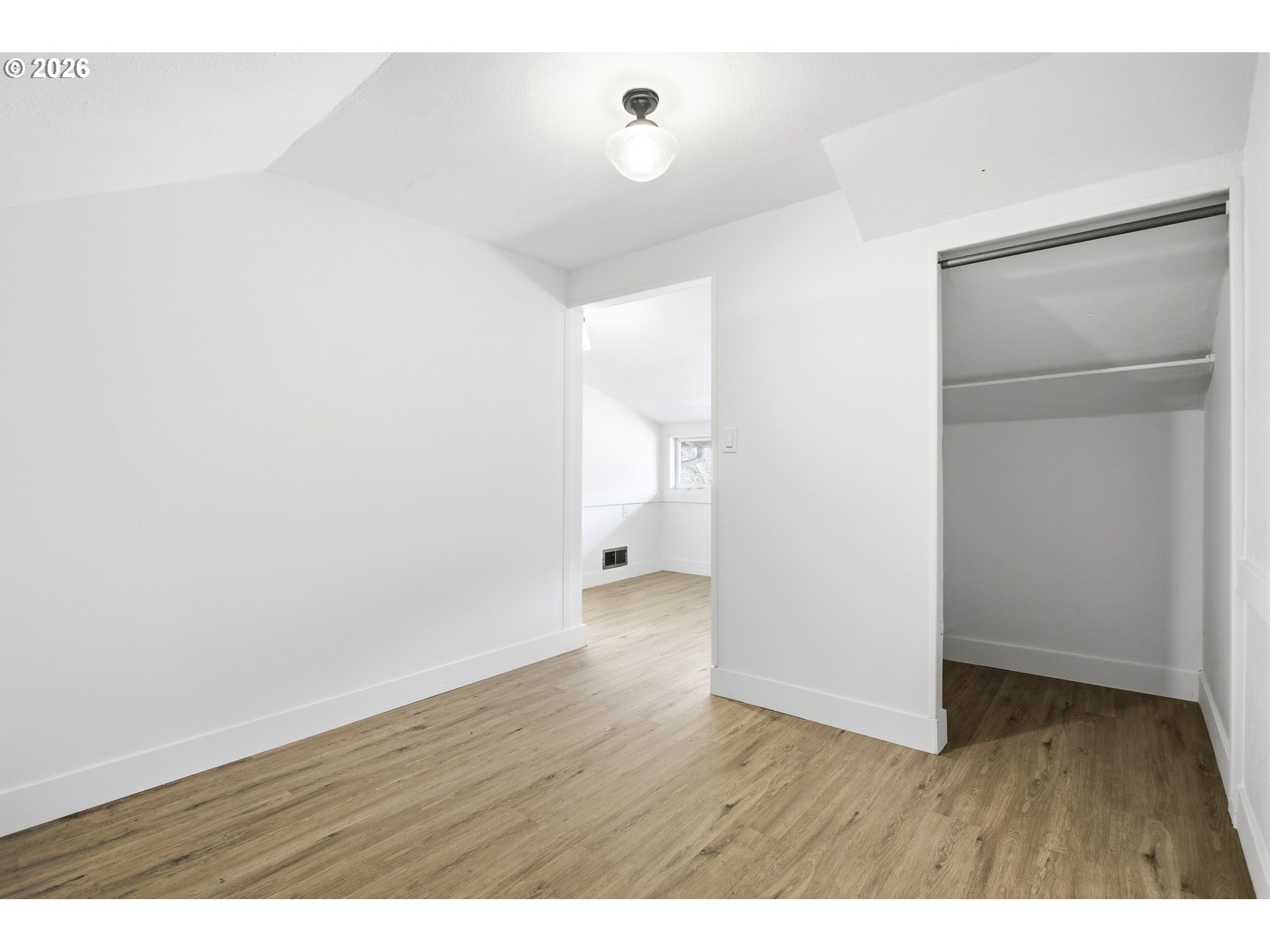 4036 Northeast Senate Street Portland, OR 97232 - Photo 25 of 48 a view of an empty room with wooden floor and a bathroom