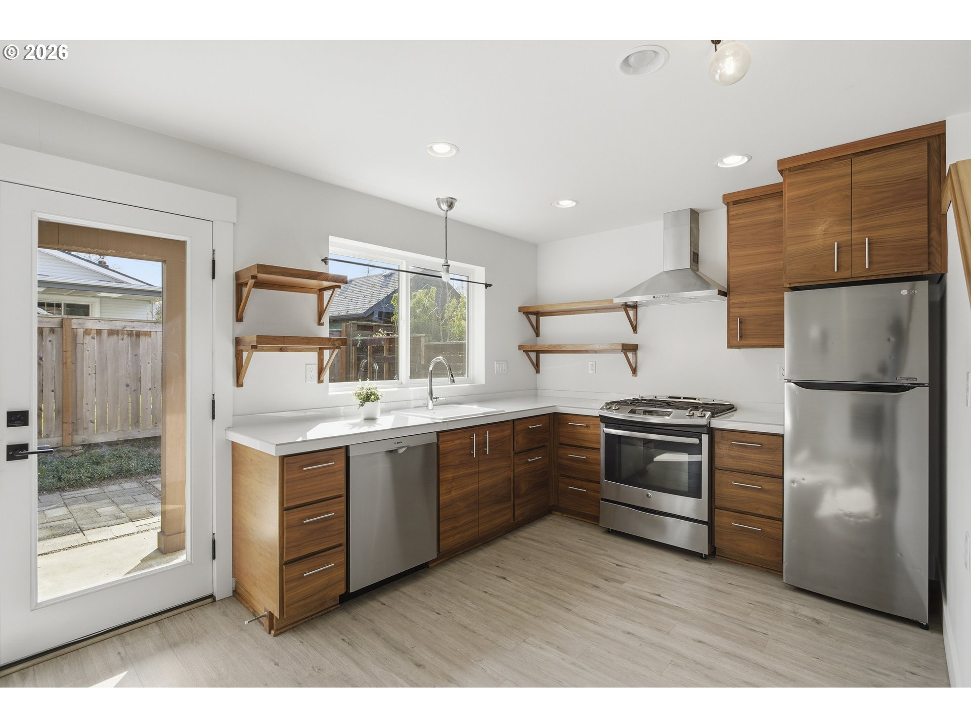 4036 Northeast Senate Street Portland, OR 97232 - Photo 29 of 48 a kitchen with stainless steel appliances granite countertop a refrigerator and a stove top oven