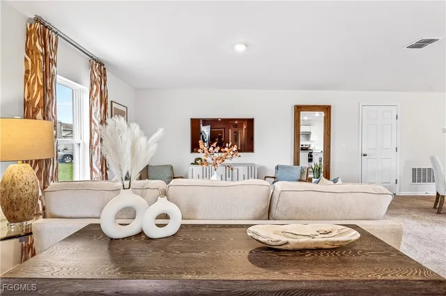 a living room with furniture and a large window