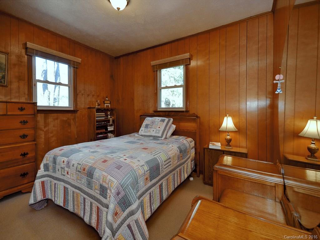 326 Robinson Road Clyde, NC 28721 - Photo 14 of 20 a bedroom with a bed and window