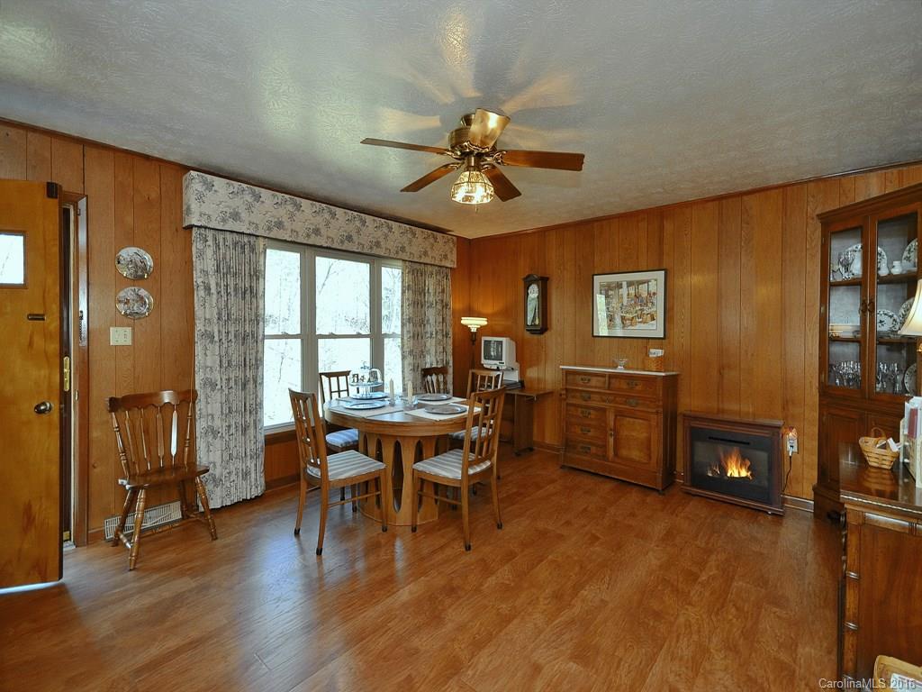 326 Robinson Road Clyde, NC 28721 - Photo 8 of 20 a dining room with furniture a chandelier and wooden floor
