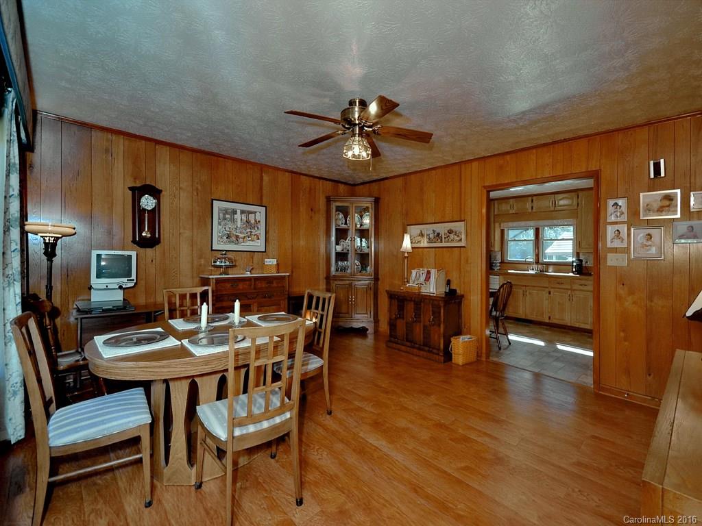 326 Robinson Road Clyde, NC 28721 - Photo 9 of 20 a view of a dining room with furniture and wooden floor