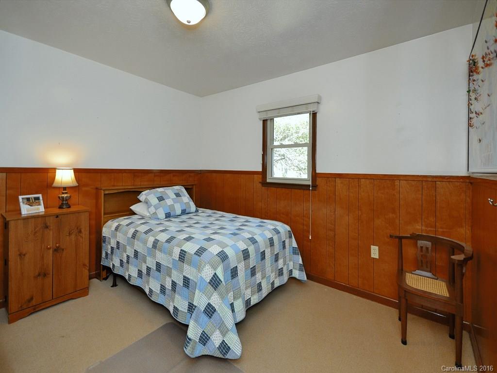 326 Robinson Road Clyde, NC 28721 - Photo 10 of 20 a bedroom with a bed and window