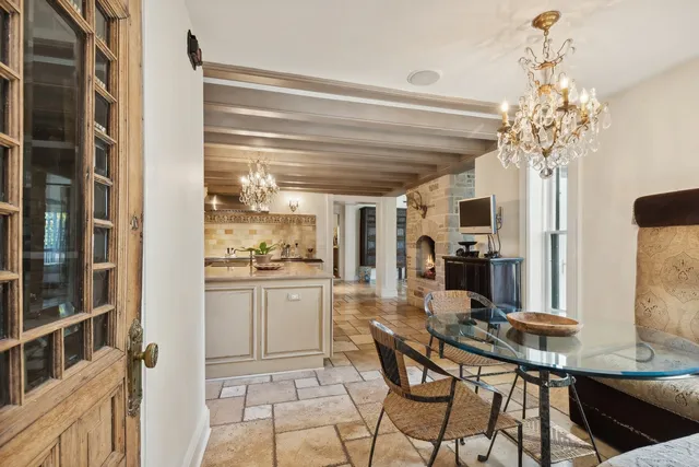 a view of a dining room with furniture and a chandelier
