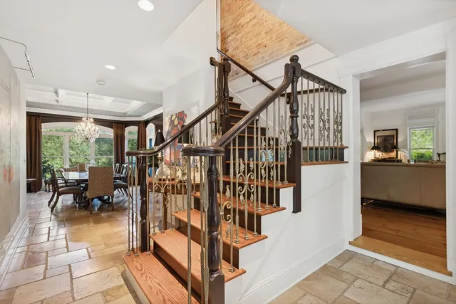 a view of staircase with furniture and a table