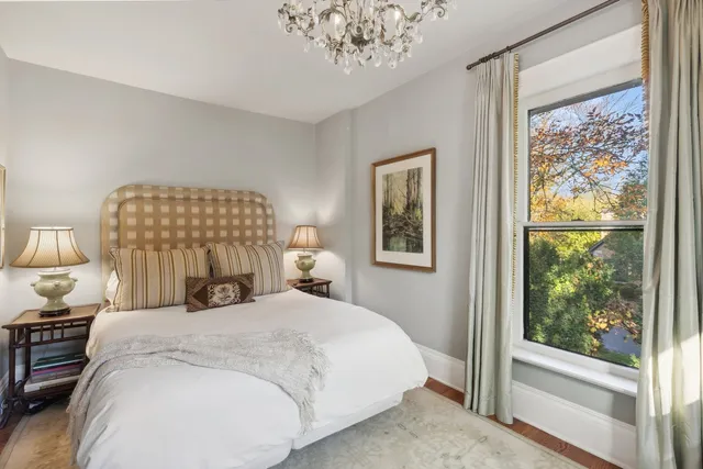 a bedroom with a large bed and a window