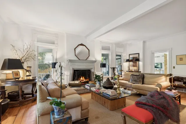 a living room with furniture fireplace and a table